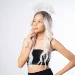 a model wearing black tanktop wig and white goddess headband crown alternative