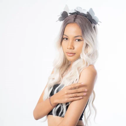 innocent flirty pose for model wearing black tanktop and butterfly headband