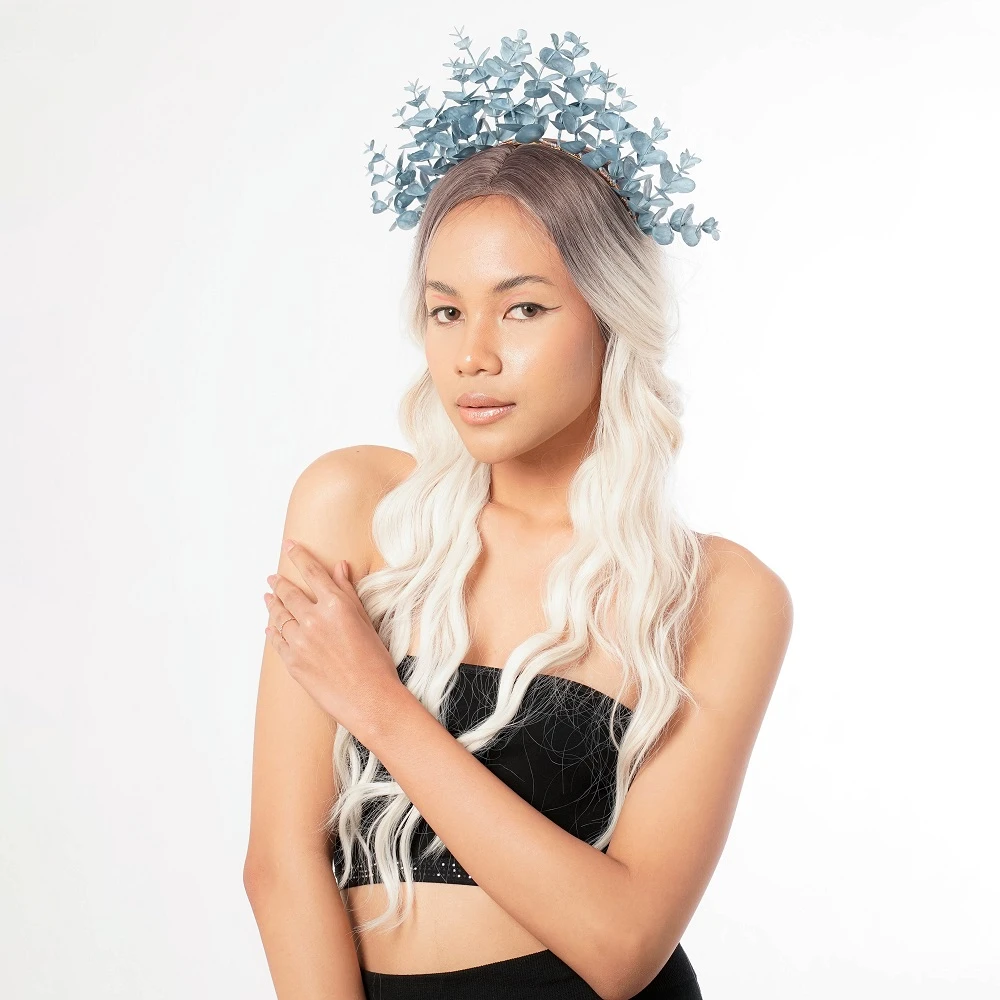 a model wearing unique bridesmaid headpiece headband crown blue color