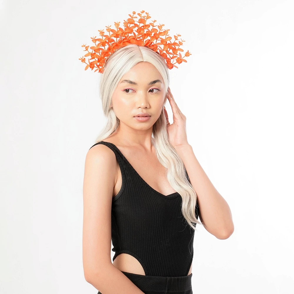 a model wearing unique bridesmaid headpiece headband crown red orange color